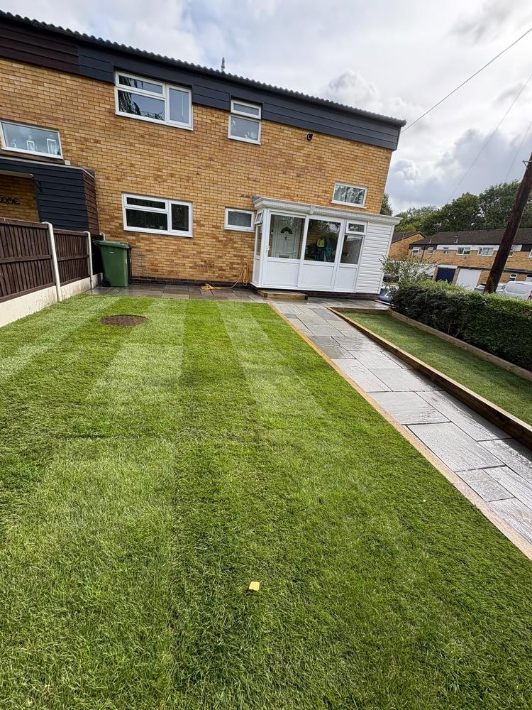 After: the same garden with the lawn laid either side of the path
