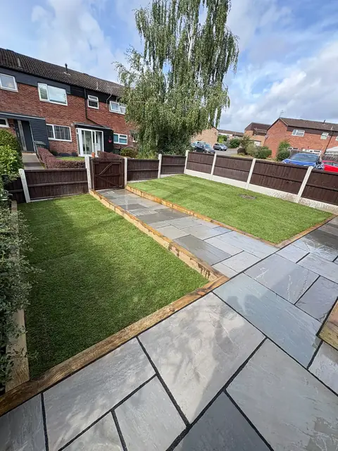 A lawn with a paved border and path running around the edge